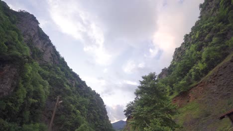 Time-lapse-video-of-forested-valley-and-sky.